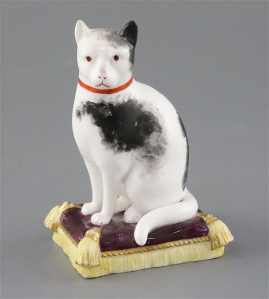 A rare Minton porcelain figure of a cat seated on a cushion, c.1835, H. 12cm